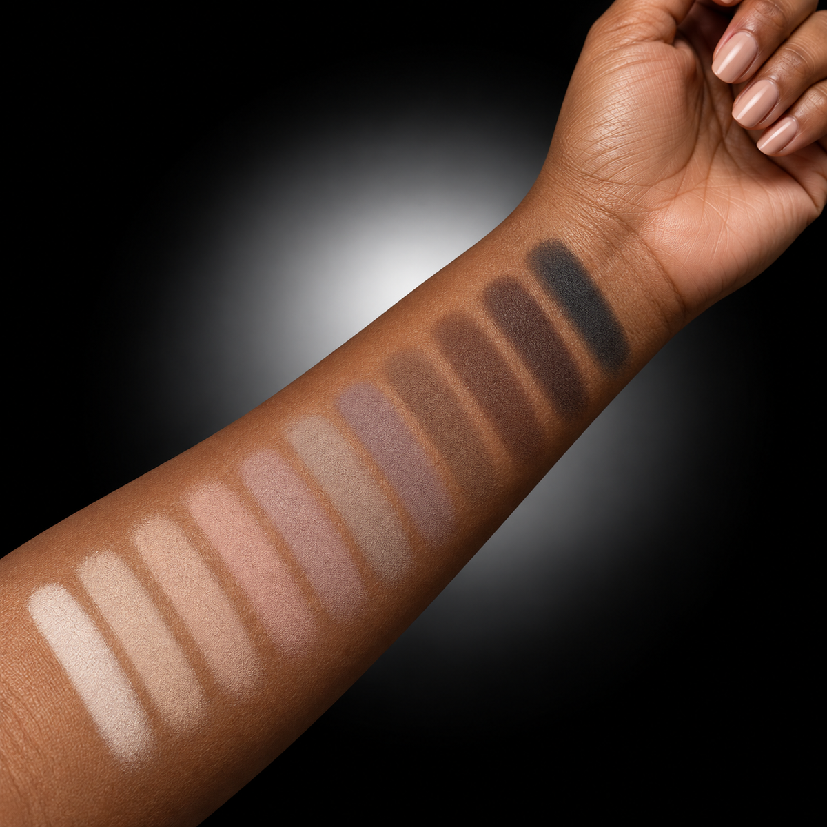 Natural Canvas Eyeshadow Palette representative neutral shades swatched on a warm brown forearm