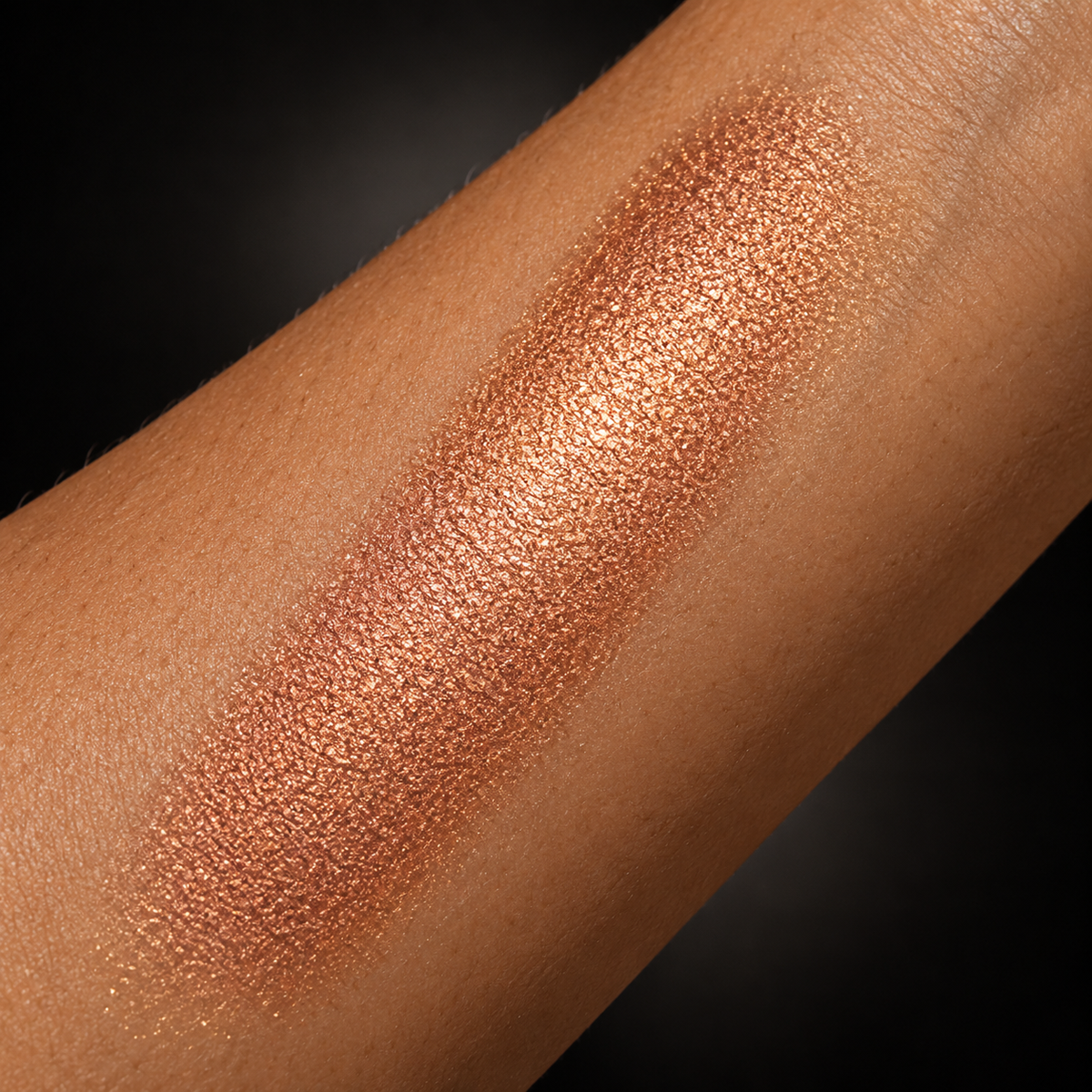 Savage bronze copper illuminator swatched on skin